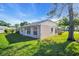 A side view reveals this home's well-maintained lawn and exterior with mature shade trees and natural light at 4819 Boonesboro Ct, New Port Richey, FL 34655