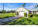 Charming home featuring a spacious garage, a well-manicured lawn, and mature landscaping at 4819 Boonesboro Ct, New Port Richey, FL 34655