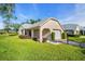 This home's exterior features manicured landscaping, a covered front porch, and an attached single-car garage at 4819 Boonesboro Ct, New Port Richey, FL 34655