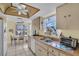 A cozy kitchen features bright, natural light, neutral-toned cabinetry, and laminate countertops at 4819 Boonesboro Ct, New Port Richey, FL 34655