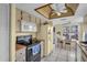 This kitchen features white tile floor, light cabinets, a modern microwave, and a white refrigerator at 4819 Boonesboro Ct, New Port Richey, FL 34655