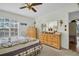 A main bedroom is complemented by a ceiling fan, a wide window with plantation shutters, and a dressing table at 4819 Boonesboro Ct, New Port Richey, FL 34655