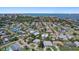 Aerial view of the neighborhood with the ocean in the background and single-Gathering homes on tree-lined streets at 5053 43Rd S St, St Petersburg, FL 33711