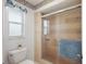Well-lit tiled bathroom featuring a modern glass shower and a low-flow toilet at 5053 43Rd S St, St Petersburg, FL 33711