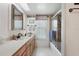 Bathroom with a large mirror, spacious vanity, and a shower-tub combo at 5053 43Rd S St, St Petersburg, FL 33711