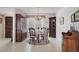 Bright dining room with a round table set, classic chandelier, and neutral tile floors perfect for gatherings at 5053 43Rd S St, St Petersburg, FL 33711