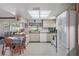 Bright, spacious kitchen with white appliances, neutral countertops, and a casual dining area with backyard views at 5053 43Rd S St, St Petersburg, FL 33711