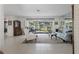 Bright living room with neutral tiled floors, comfortable seating and large windows to enjoy the backyard view at 5053 43Rd S St, St Petersburg, FL 33711