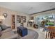 Cozy living area with a comfortable sofa, built-in bookcase, and view of the backyard lanai at 5053 43Rd S St, St Petersburg, FL 33711