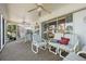 A covered patio with comfortable seating and an outdoor view with a decorative pillow at 5053 43Rd S St, St Petersburg, FL 33711