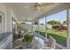 A covered patio seating area with a glass table and view of the landscaped backyard at 5053 43Rd S St, St Petersburg, FL 33711