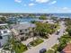 Aerial view of luxury home with lush landscaping, circular driveway, and waterfront community at 5142 W San Jose St, Tampa, FL 33629