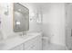 Bright bathroom with a white vanity, gold hardware, and glass shower door at 5142 W San Jose St, Tampa, FL 33629