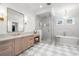Luxurious bathroom with marble floors, a soaking tub, and a glass shower at 5142 W San Jose St, Tampa, FL 33629