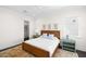 Cozy bedroom featuring a woven headboard, side tables with lamps, and view to a walk-in closet at 5142 W San Jose St, Tampa, FL 33629