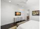 Tranquil bedroom with a dresser, a view of the ensuite bathroom and natural light at 5142 W San Jose St, Tampa, FL 33629