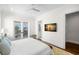 Bright bedroom with hardwood floors and balcony access, showcasing a cozy and inviting space at 5142 W San Jose St, Tampa, FL 33629