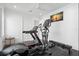 Home gym featuring a treadmill, elliptical, weight bench, and ample natural light at 5142 W San Jose St, Tampa, FL 33629