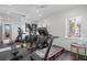 Well-equipped home gym with treadmill, elliptical, weight bench, and mirrored wall at 5142 W San Jose St, Tampa, FL 33629