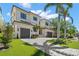 Two-story home with a paver driveway, lush landscaping, and a convenient two-car garage enhancing curb appeal at 5142 W San Jose St, Tampa, FL 33629
