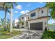 Two-story home with a paver driveway, lush landscaping, and a convenient two-car garage enhancing curb appeal at 5142 W San Jose St, Tampa, FL 33629
