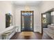 Stunning foyer with dark hardwood floors, leading to additional rooms and featuring natural light at 5142 W San Jose St, Tampa, FL 33629