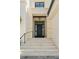 Elegant home entrance featuring a modern black door, detailed stonework, and classic outdoor lighting at 5142 W San Jose St, Tampa, FL 33629