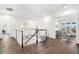 Hallway with dark wood floors, white trim, and a decorative chandelier at 5142 W San Jose St, Tampa, FL 33629