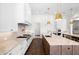 Gourmet kitchen with stainless steel appliances, custom cabinetry, and a large center island with seating at 5142 W San Jose St, Tampa, FL 33629