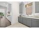 Kitchenette with gray cabinets, light countertops and view into the kitchen at 5142 W San Jose St, Tampa, FL 33629