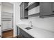 Laundry room with white marble counters, dark gray cabinets, and a walk-in closet at 5142 W San Jose St, Tampa, FL 33629