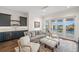 Comfortable living room features gray furniture, dark wood floors, wet bar and water views from balcony at 5142 W San Jose St, Tampa, FL 33629