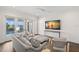 Open living room featuring water views, neutral decor, and a large screen television at 5142 W San Jose St, Tampa, FL 33629