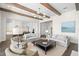 Open-concept living room with wood beams, neutral decor, and view into the bright kitchen space at 5142 W San Jose St, Tampa, FL 33629