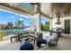 Inviting covered patio with comfortable seating, summer kitchen, and views of the canal and pool at 5142 W San Jose St, Tampa, FL 33629