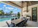 Outdoor kitchen featuring a large table, a grill, and a view of the intercoastal waterway and pool at 5142 W San Jose St, Tampa, FL 33629