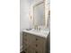 Elegant powder room with decorative mirror, wall sconces, and neutral-toned vanity at 5142 W San Jose St, Tampa, FL 33629