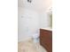 Bathroom featuring a wooden vanity, a mirror, and a toilet, combining style and functionality at 5421 Orange Blossom N Rd, Pinellas Park, FL 33782