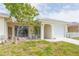 Charming one-story home with a well-manicured lawn, inviting curb appeal, and an attached garage at 5421 Orange Blossom N Rd, Pinellas Park, FL 33782