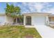Inviting single-story home with a well-maintained lawn, driveway, and attached garage at 5421 Orange Blossom N Rd, Pinellas Park, FL 33782
