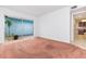 Living room featuring carpet, sliding glass doors with a view of the outside patio at 5421 Orange Blossom N Rd, Pinellas Park, FL 33782