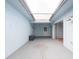 Enclosed patio with a skylight, a ceiling fan, and access doors, offering a versatile outdoor space at 5421 Orange Blossom N Rd, Pinellas Park, FL 33782