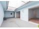 Enclosed patio with a skylight, a ceiling fan, and access doors, offering a versatile outdoor space at 5421 Orange Blossom N Rd, Pinellas Park, FL 33782