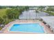 Inviting community pool with lounge chairs, tables, and scenic water views, ideal for relaxation at 5421 Orange Blossom N Rd, Pinellas Park, FL 33782