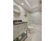 Bright bathroom featuring a modern vanity, toilet, and shower-tub combo with sliding glass doors at 5575 Gulf Blvd # 329, St Pete Beach, FL 33706