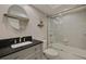 Bright bathroom featuring a modern vanity, toilet, and shower-tub combo with sliding glass doors at 5575 Gulf Blvd # 329, St Pete Beach, FL 33706