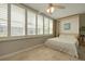 Cozy bedroom featuring a murphy bed, tile flooring, and plantation shutters at 5575 Gulf Blvd # 329, St Pete Beach, FL 33706