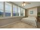 Bedroom featuring tile floors, murphy bed, and shuttered windows overlooking city at 5575 Gulf Blvd # 329, St Pete Beach, FL 33706