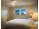 Bedroom featuring a window with view, light walls, and a ceiling fan at 5575 Gulf Blvd # 329, St Pete Beach, FL 33706