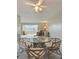 Cozy dining area featuring a glass-top table and seating for four, bathed in natural light at 5575 Gulf Blvd # 329, St Pete Beach, FL 33706
